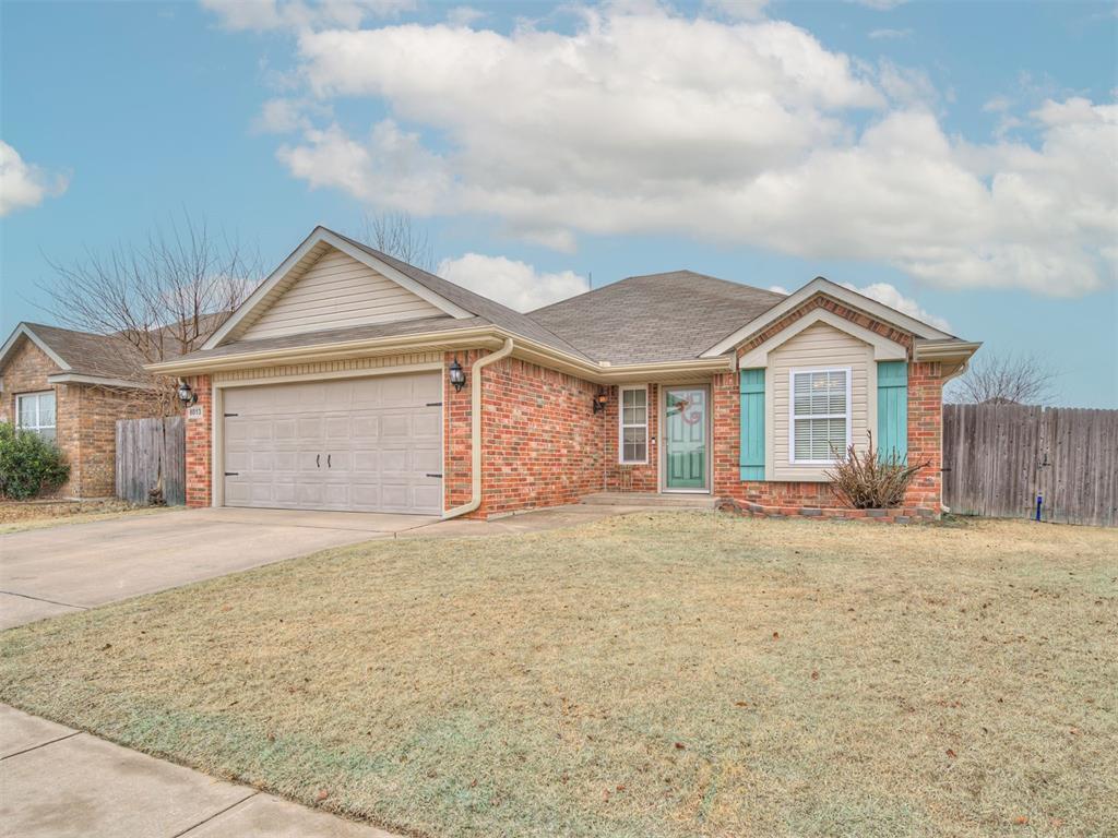 ranch-style home featuring a garage and a front yard