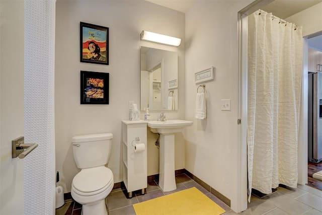 bathroom featuring tile patterned floors and toilet