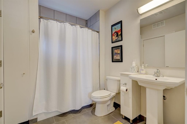 bathroom with sink, tile patterned floors, and toilet