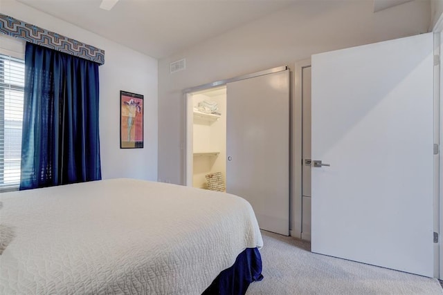 bedroom featuring light carpet and ceiling fan