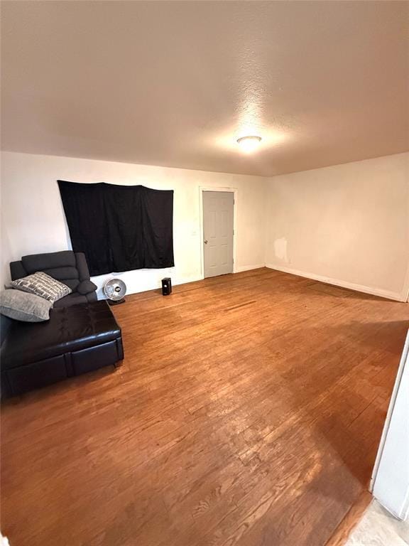 living area featuring light wood-style floors and baseboards