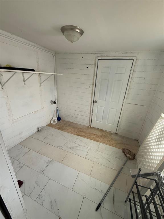 laundry area with marble finish floor