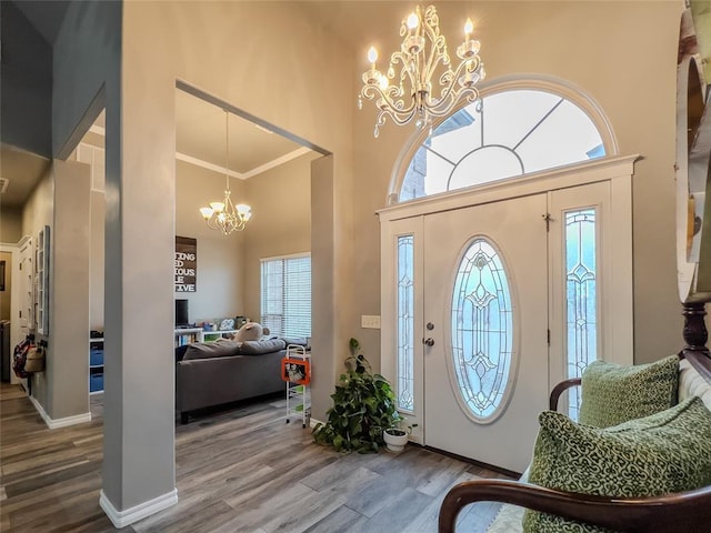 3629 W County Street 2850th St, Ninnekah, OK 73067 - foyer featuring a notable chandelier, a high ceiling, baseboards, and wood finished floors