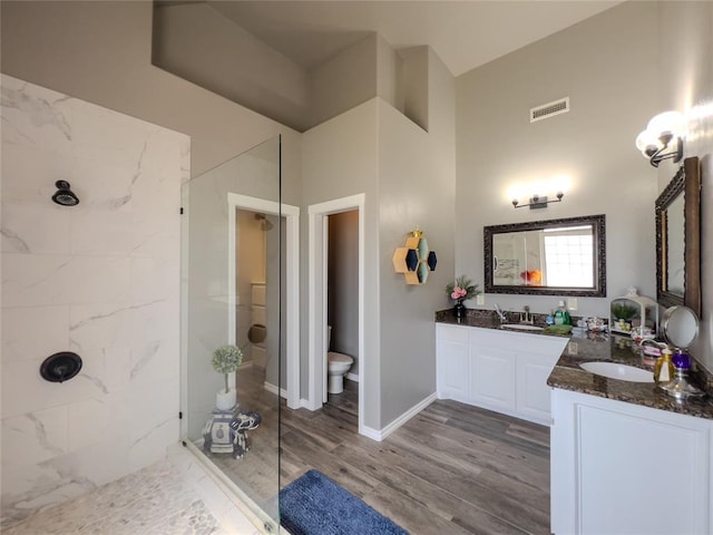 3629 W County Street 2850th St, Ninnekah, OK 73067 - bathroom with a sink, visible vents, tiled shower, and wood finished floors