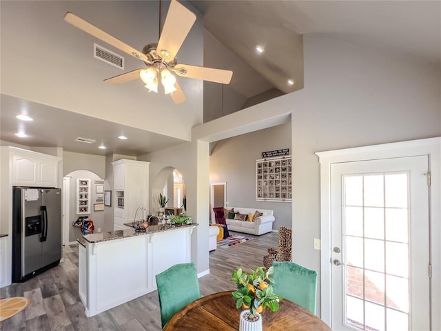 3629 W County Street 2850th St, Ninnekah, OK 73067 - kitchen with visible vents, white cabinets, arched walkways, stainless steel refrigerator with ice dispenser, and stone counters
