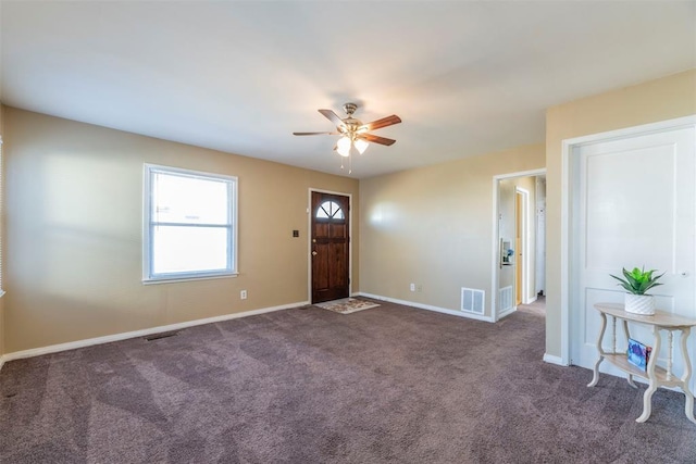 carpeted foyer entrance featuring ceiling fan