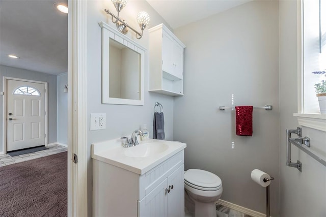 bathroom featuring vanity and toilet