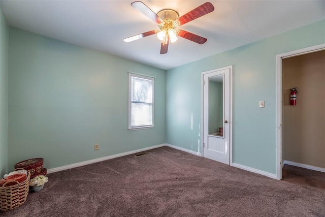 carpeted empty room featuring ceiling fan