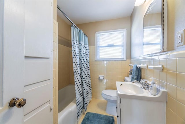 full bathroom featuring vanity, tile walls, shower / bath combination with curtain, and toilet