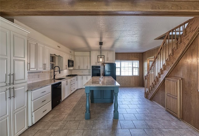 kitchen with a kitchen island, white cabinetry, a breakfast bar area, hanging light fixtures, and black appliances