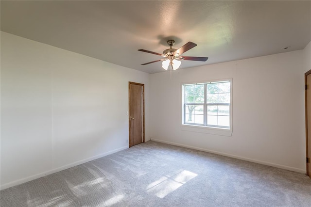 spare room featuring carpet and ceiling fan