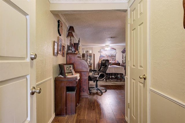 hall featuring hardwood / wood-style floors and a textured ceiling