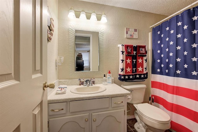 bathroom featuring tile patterned flooring, a shower with shower curtain, vanity, a textured ceiling, and toilet