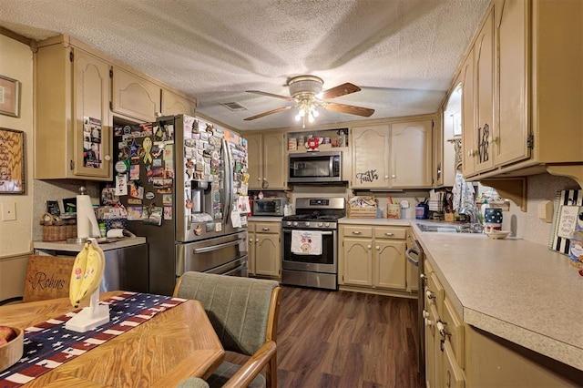 kitchen with sink, a textured ceiling, appliances with stainless steel finishes, dark hardwood / wood-style floors, and ceiling fan