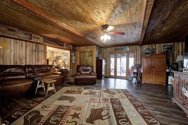 living room with dark hardwood / wood-style flooring, wooden walls, ceiling fan, and wood ceiling