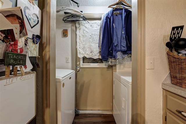 clothes washing area featuring washing machine and clothes dryer and dark hardwood / wood-style flooring