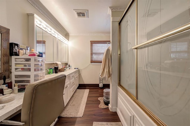 bathroom with vanity, crown molding, wood-type flooring, and enclosed tub / shower combo