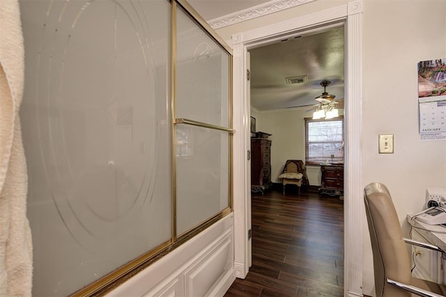 corridor featuring dark wood-type flooring and ornamental molding