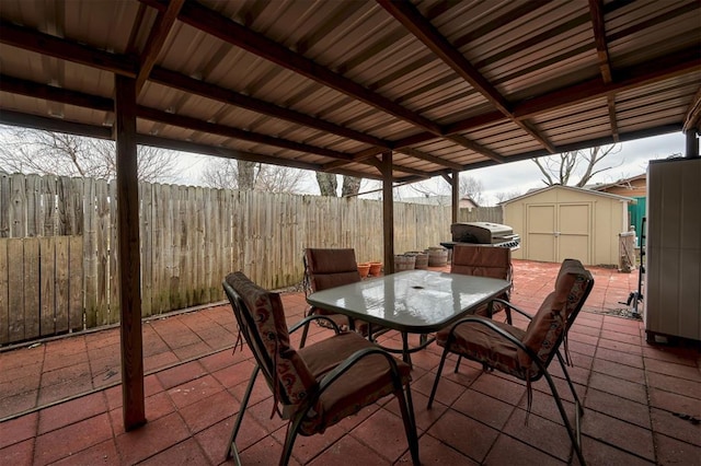 view of patio featuring grilling area and a storage shed