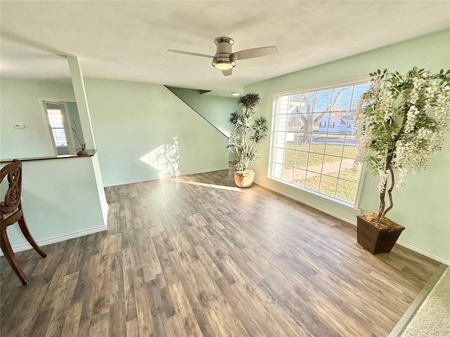 unfurnished room with plenty of natural light, hardwood / wood-style floors, and ceiling fan