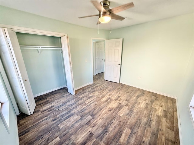 unfurnished bedroom featuring dark hardwood / wood-style flooring, a closet, and ceiling fan