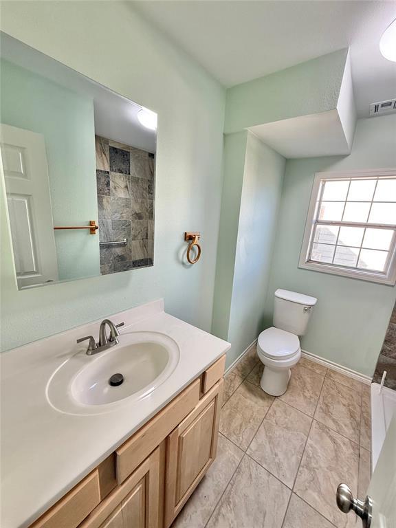 bathroom featuring vanity and toilet