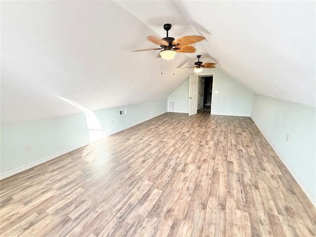 additional living space featuring lofted ceiling and light wood-type flooring