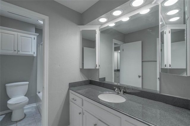 bathroom featuring tile patterned floors, vanity, and toilet