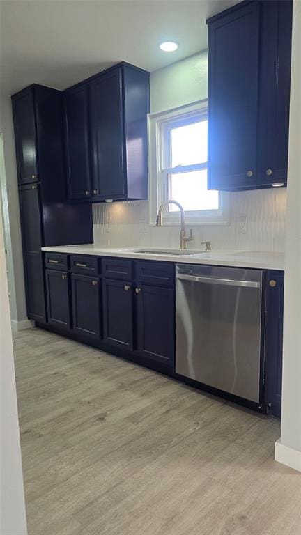 kitchen featuring sink, light hardwood / wood-style flooring, blue cabinetry, and dishwasher