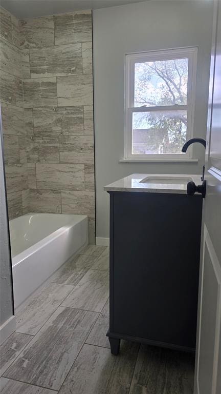 bathroom with vanity and tiled shower / bath combo