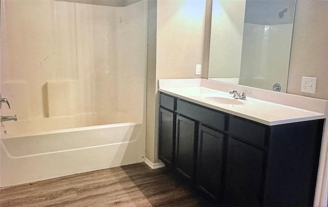 bathroom with shower / bathing tub combination, vanity, and hardwood / wood-style flooring