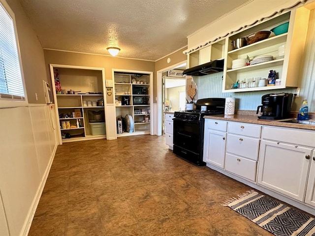 kitchen with black gas range oven, white cabinets, a textured ceiling, and open shelves