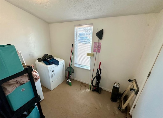 clothes washing area featuring carpet, baseboards, laundry area, washer / clothes dryer, and a textured ceiling