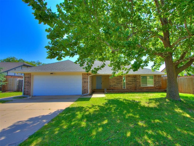 720 Cottonwood Dr, Moore, OK 73160 - view of front of property featuring a garage, driveway, brick siding, and a shingled roof