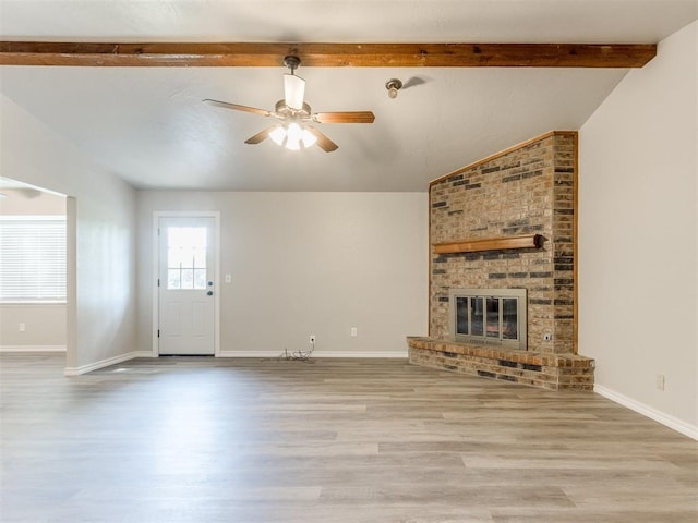 720 Cottonwood Dr, Moore, OK 73160 - unfurnished living room with wood finished floors, a ceiling fan, baseboards, and a brick fireplace