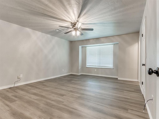 720 Cottonwood Dr, Moore, OK 73160 - unfurnished room featuring ceiling fan, baseboards, and wood finished floors