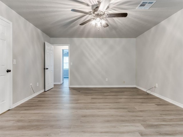 720 Cottonwood Dr, Moore, OK 73160 - empty room featuring a ceiling fan, light wood-style floors, and baseboards