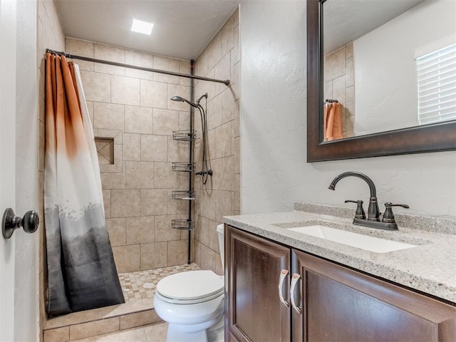 720 Cottonwood Dr, Moore, OK 73160 - bathroom with vanity, tiled shower, toilet, and a textured wall