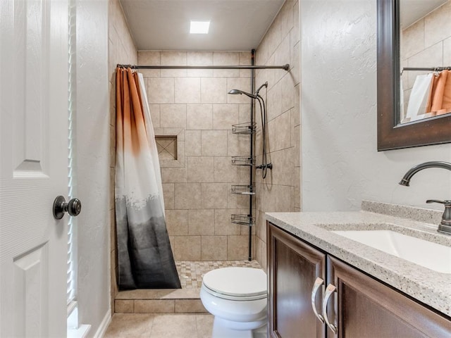 720 Cottonwood Dr, Moore, OK 73160 - bathroom featuring vanity, toilet, tiled shower, tile patterned floors, and a textured wall