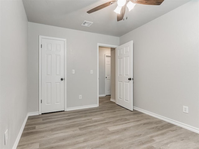 720 Cottonwood Dr, Moore, OK 73160 - unfurnished bedroom with light wood-style floors, baseboards, and a ceiling fan