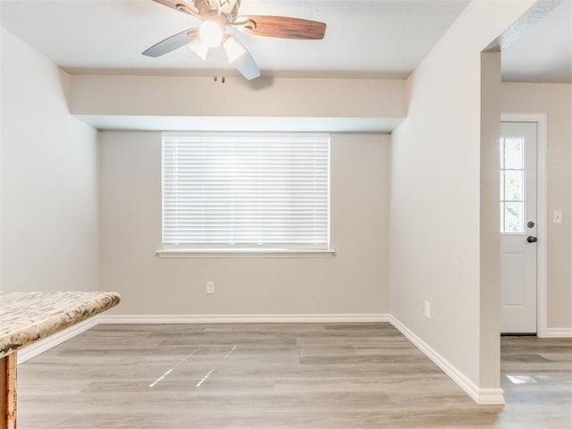 720 Cottonwood Dr, Moore, OK 73160 - empty room with wood finished floors, ceiling fan, and baseboards