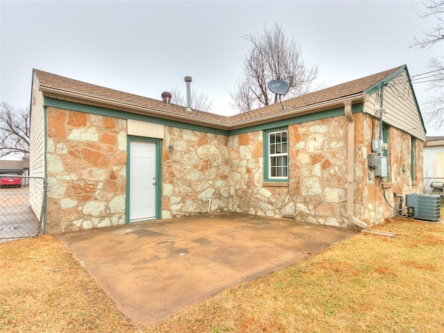 rear view of property featuring central AC and a patio area