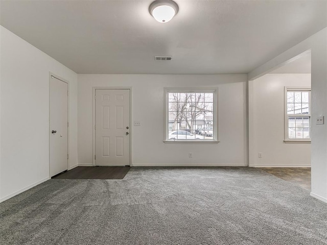 empty room with dark carpet