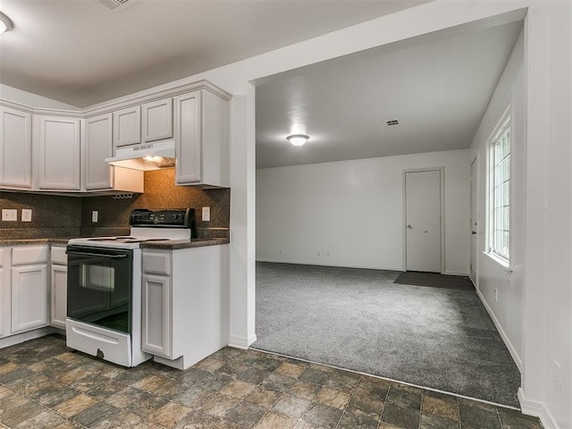 kitchen featuring white cabinetry, dark colored carpet, backsplash, and range with electric stovetop