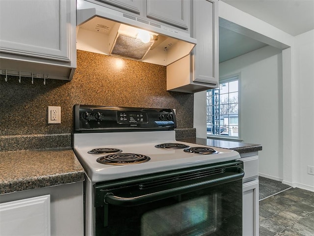 kitchen with electric range and backsplash