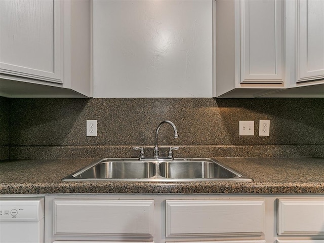 kitchen featuring white cabinetry, sink, white dishwasher, and decorative backsplash