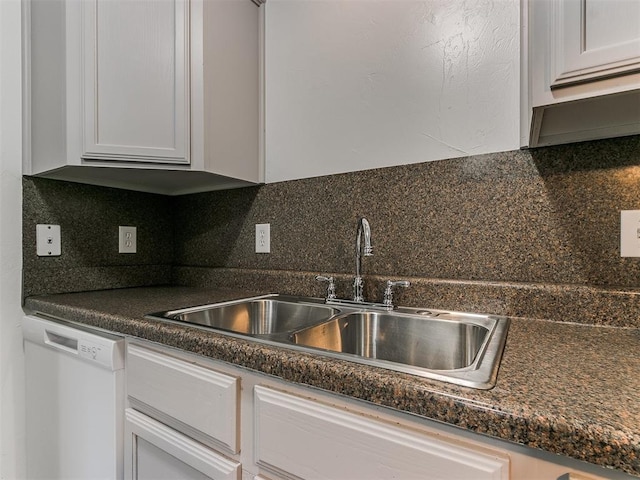 kitchen with white cabinetry, dishwasher, sink, and tasteful backsplash