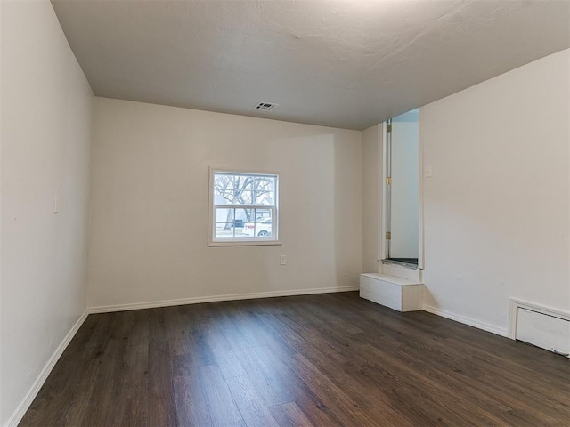 spare room featuring dark hardwood / wood-style floors