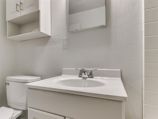 bathroom with vanity and toilet