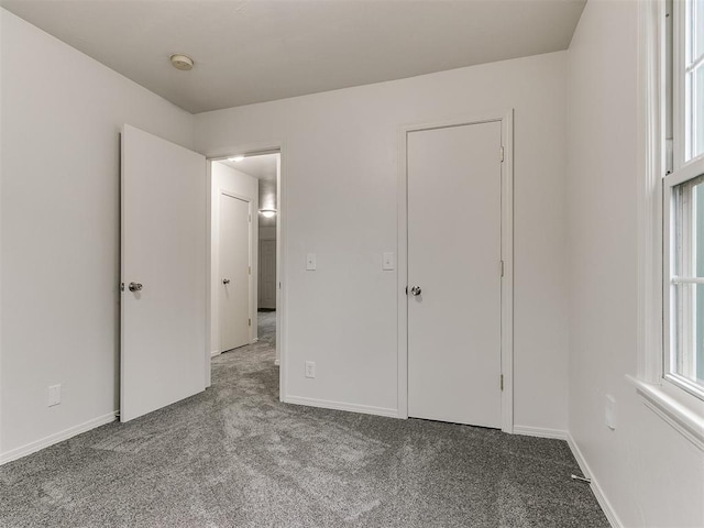 unfurnished bedroom with light colored carpet